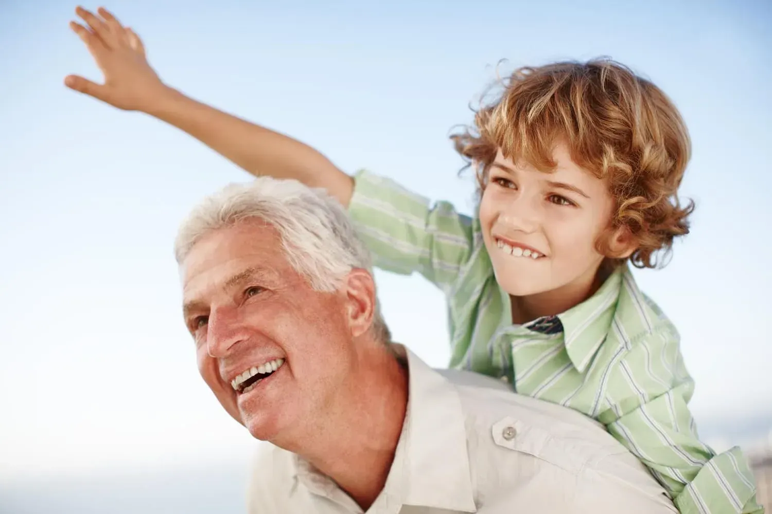 Happy grandfather and grandson enjoying outdoor fun