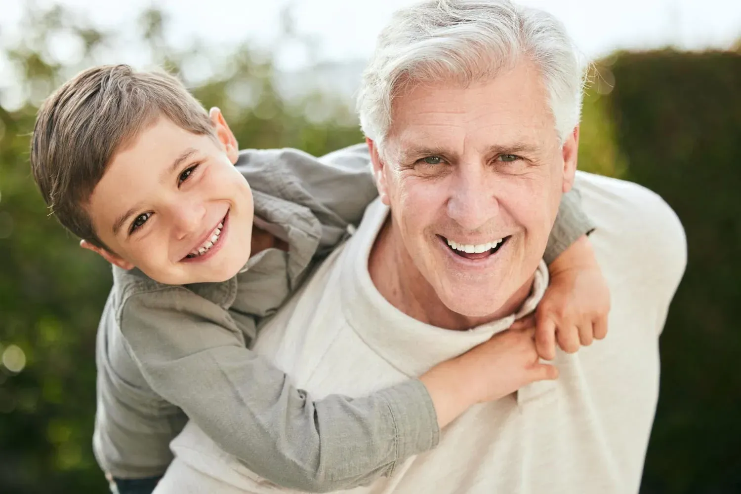Happy grandfather and grandson enjoying outdoor time together