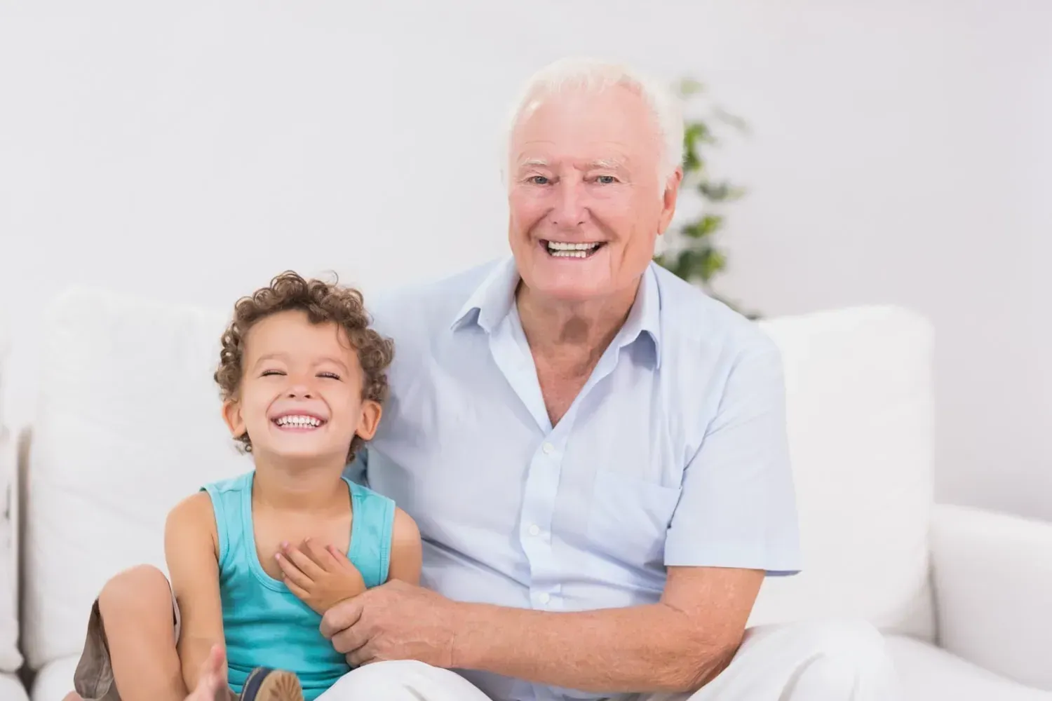 Happy grandfather with granddaughter at home