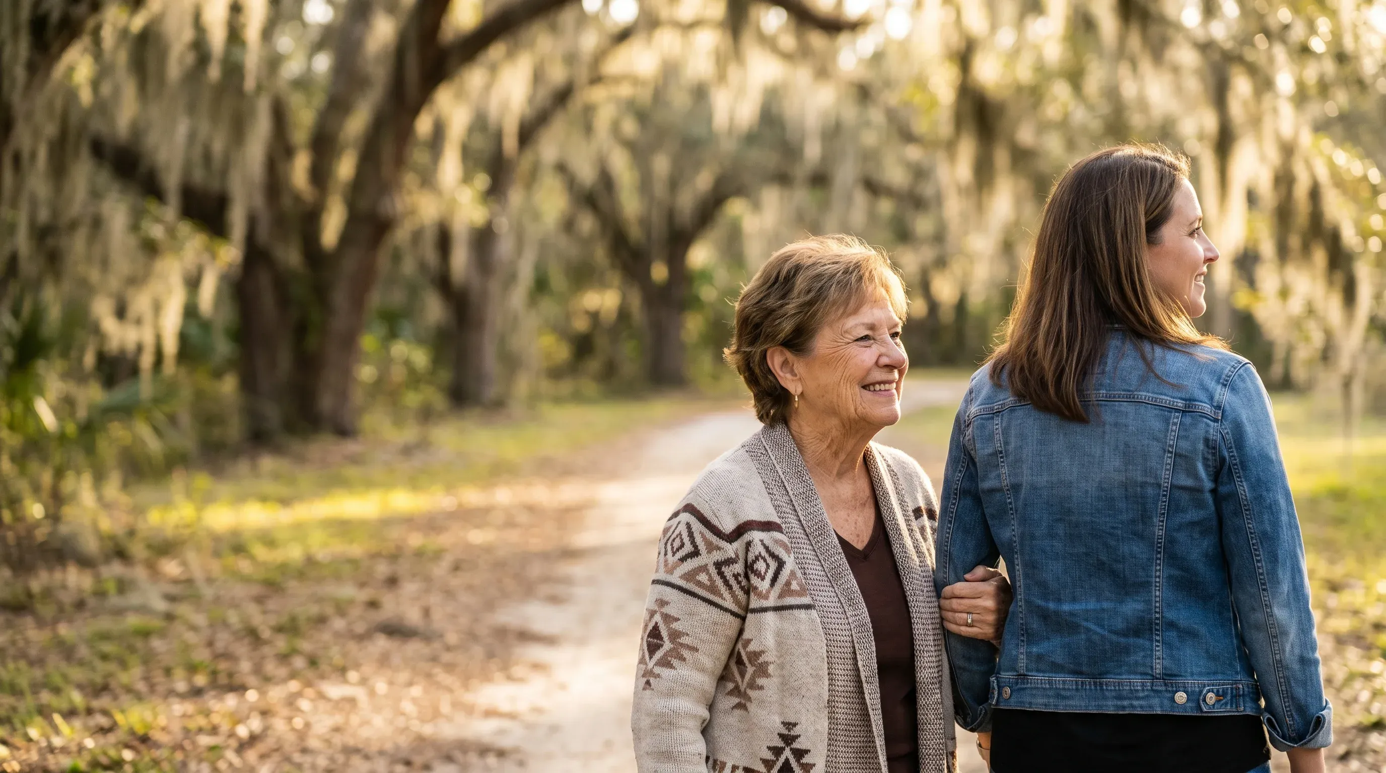 Grandmother smiling as she walks arm in arm with her daughter in a Central Florida park.