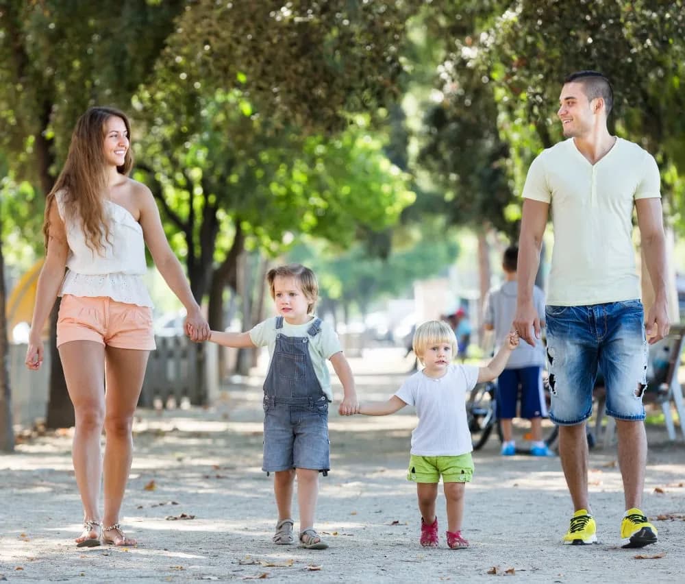 Family enjoying a walk outdoors in Minneola, Florida, with bright smiles and happy faces.