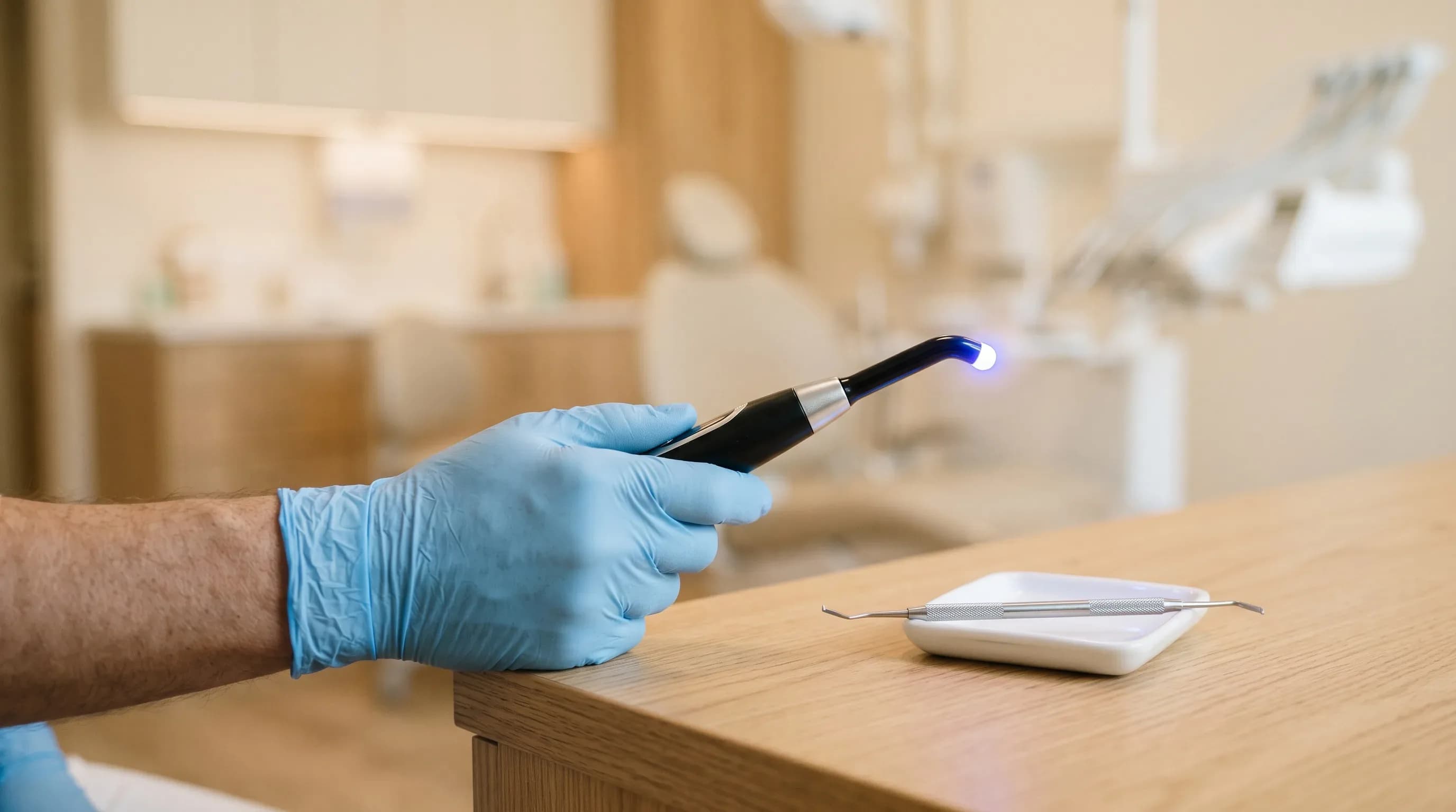 Dentist holding a curing light used to set a tooth-colored composite filling