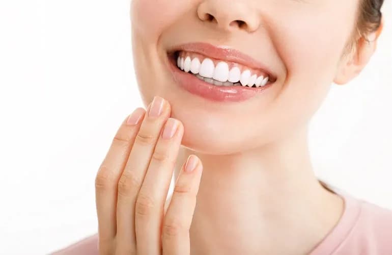 Woman with a healthy, flawless white smile — porcelain veneers and dental crowns at Neola Dental in Minneola, FL