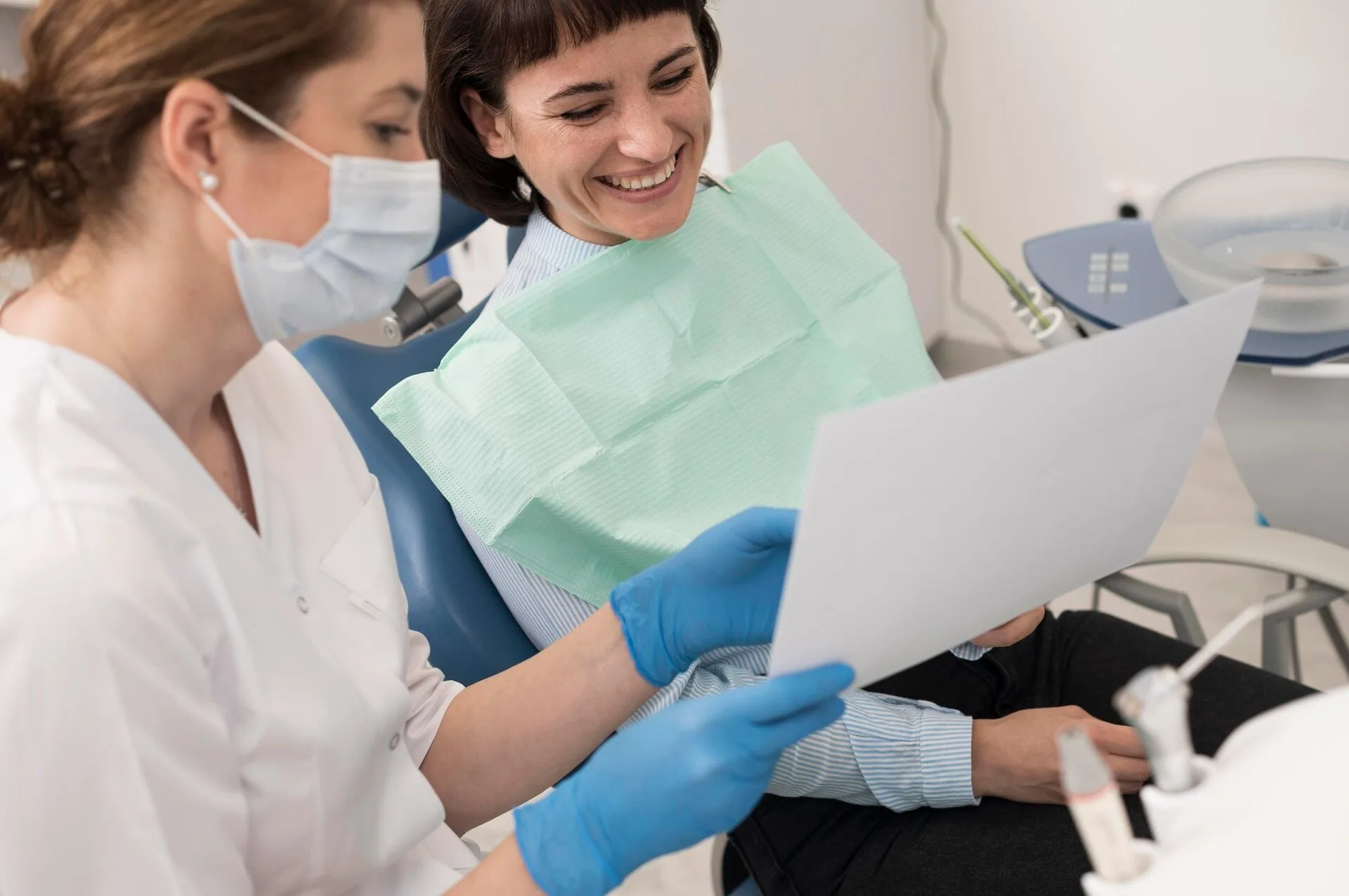 Dentist reviewing a patient's dental radiography during an emergency visit at Neola Dental in Minneola, FL