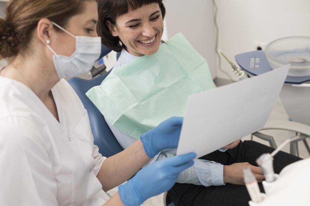 female patient looking radiography her teeth with dentist