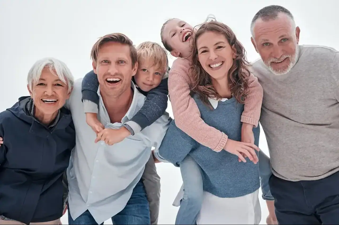 Multi-generational family smiling together representing family dental care in Minneola Florida
